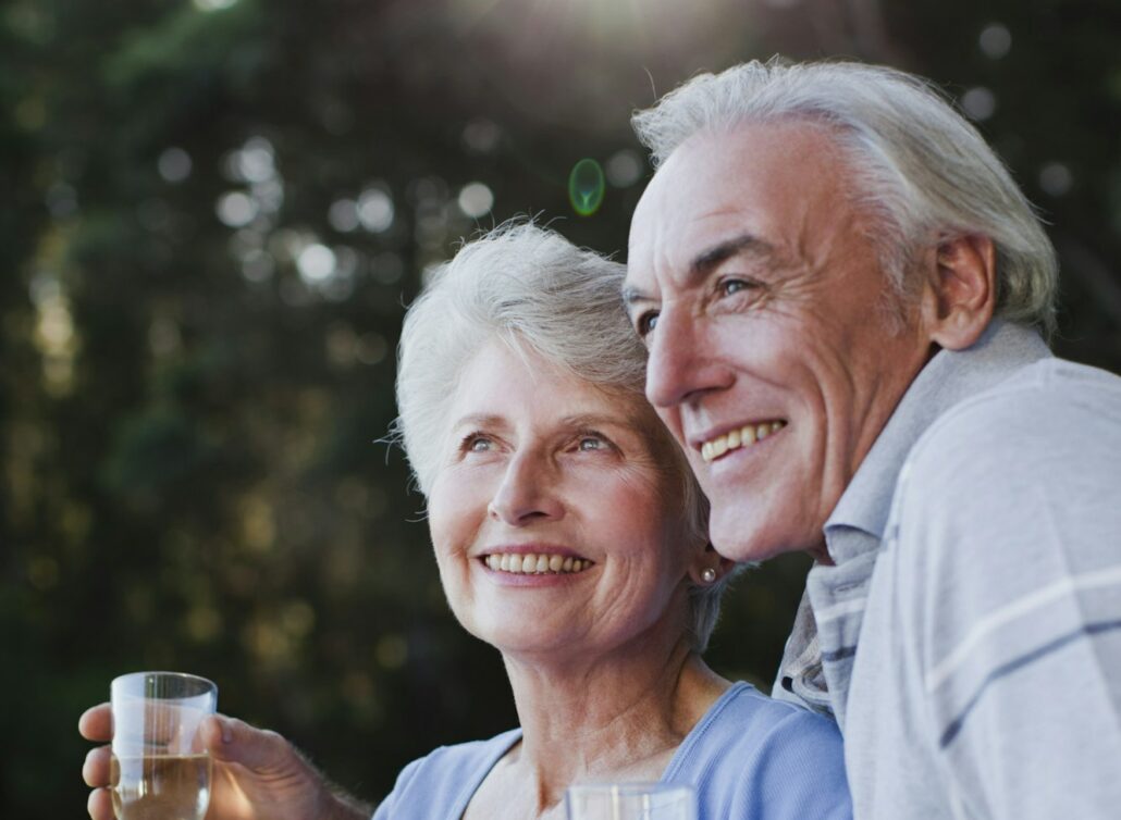 Older couple drinking wine outdoors